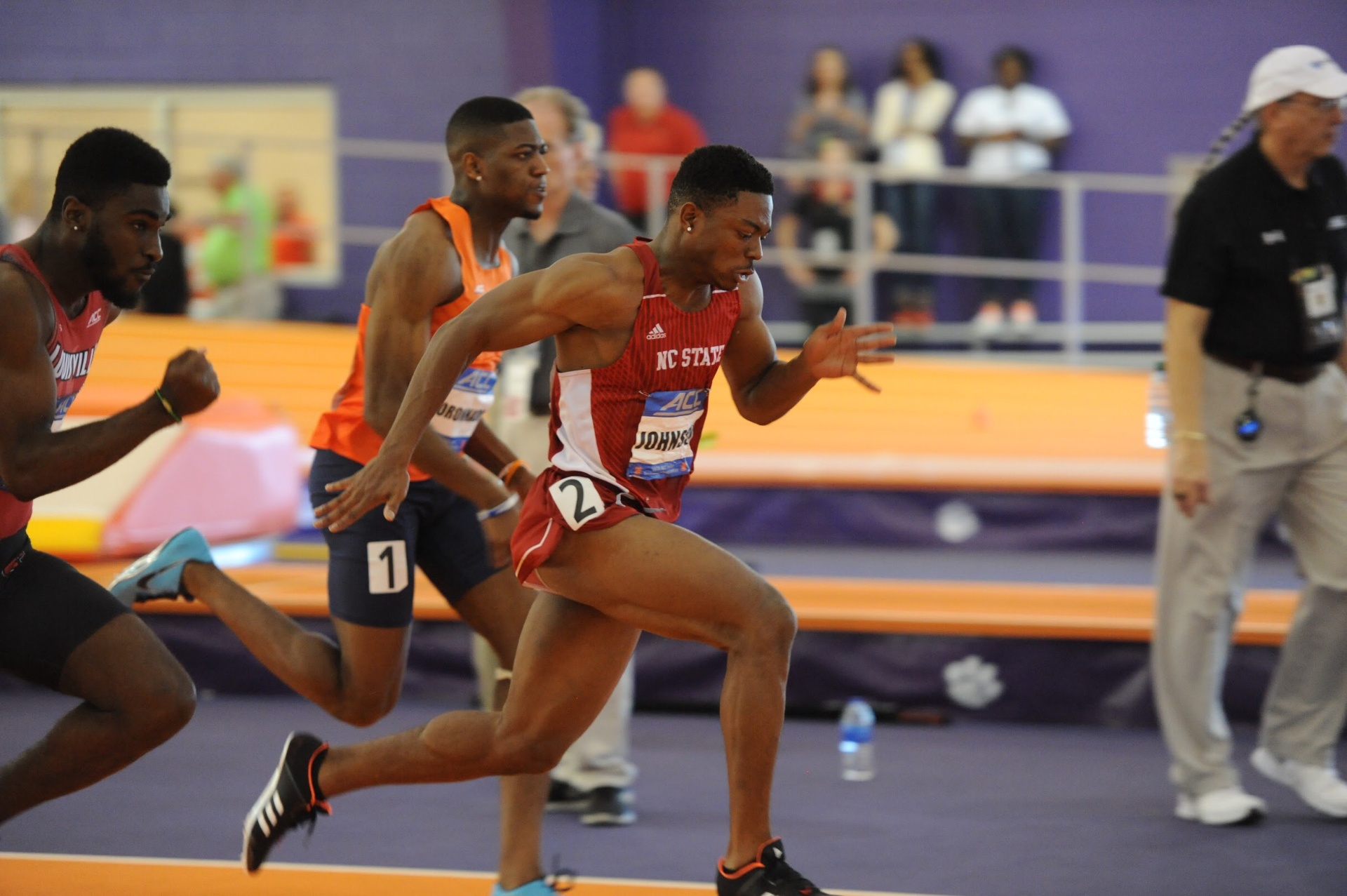 Sprinter exploding out of the blocks at an ACC indoor meet